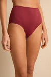 anja bikini high-waisted bikini bottom la magnétique terracotta close up face